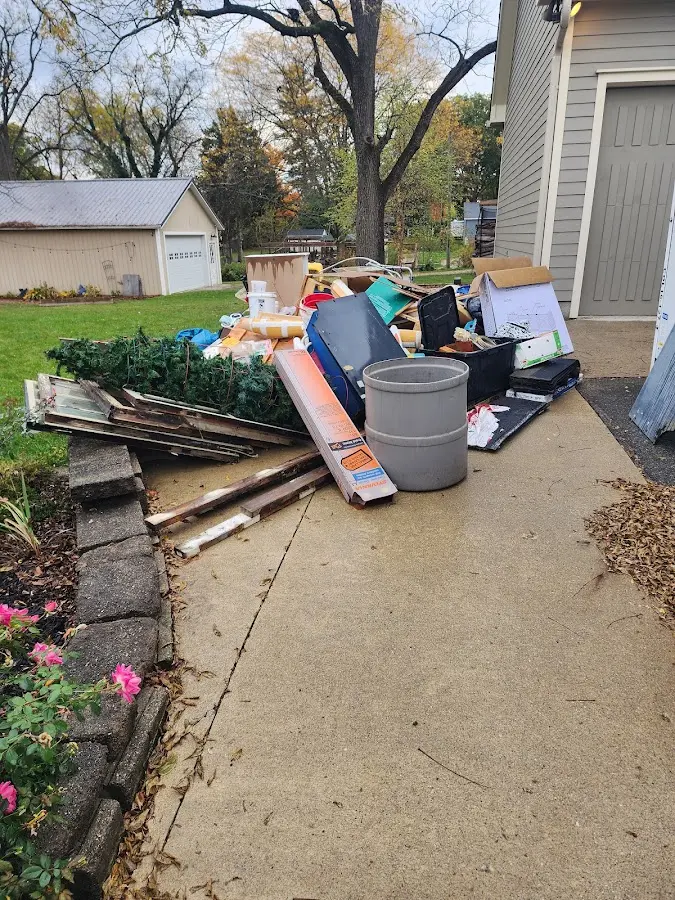 Dumpster being loaded with debris for Estate Cleanout Dumpster Rental in Selmer